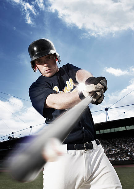 Baseball player swinging baseball bat  baseball hitter stock pictures, royalty-free photos & images