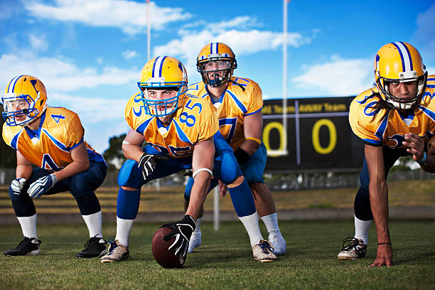 Football players preparing to play football  offensive line stock pictures, royalty-free photos & images