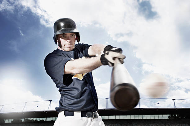 Baseball player swinging baseball bat  baseball player at bat stock pictures, royalty-free photos & images