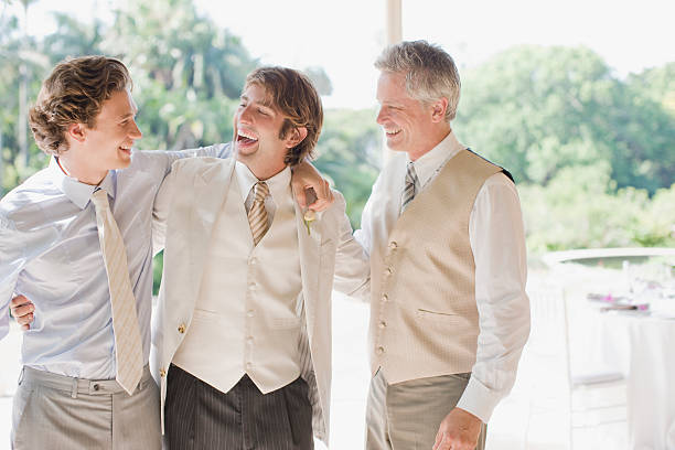 Groom and groomsmen hugging  20 29 years photos stock pictures, royalty-free photos & images