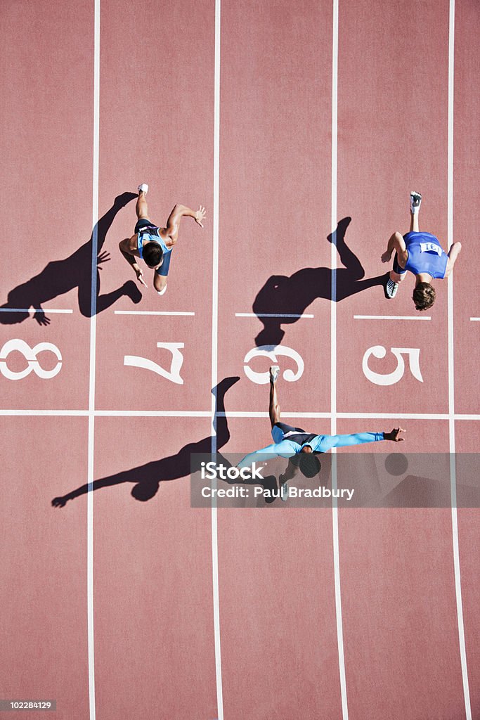 Runner crossing finishing line on track  Winning Stock Photo