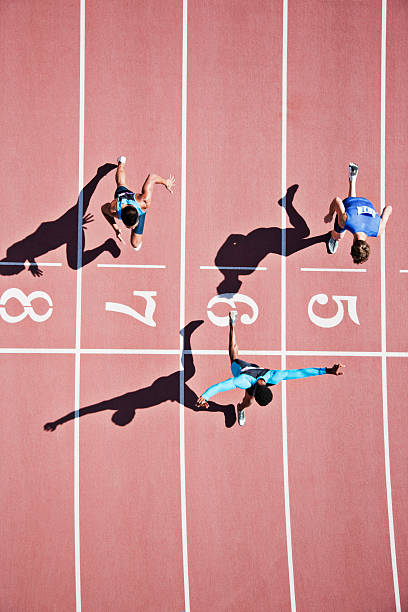 Runner crossing finishing line on track  sports track photos stock pictures, royalty-free photos & images