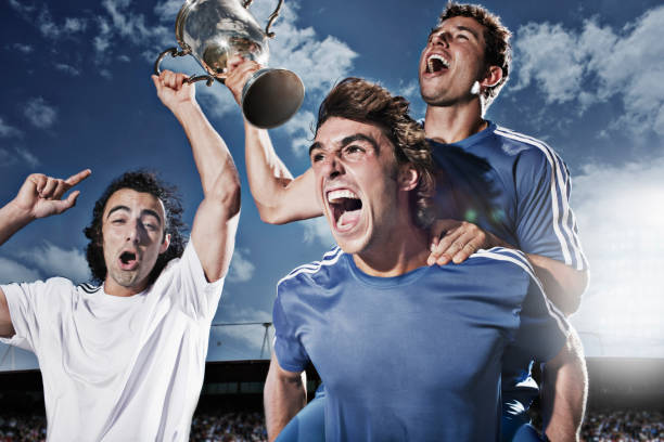 Soccer players cheering with trophy  cheering group of people success looking at camera stock pictures, royalty-free photos & images