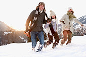 Family running outdoors in snow