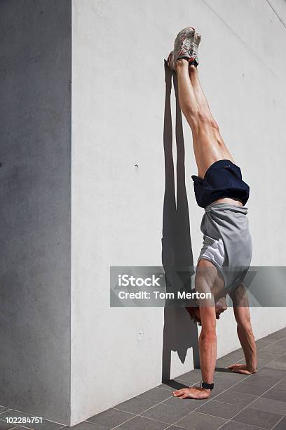 Man Doing Handstand In Urban Setting Stock Photo - Download Image Now - Handstand, Men, 25-29 Years