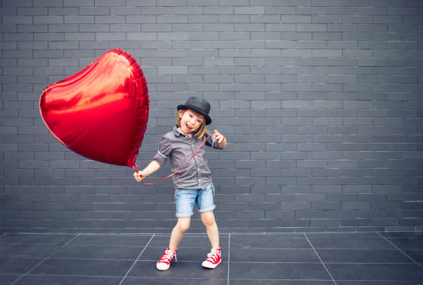 istock Boy with heart shape air balloon 1022849986