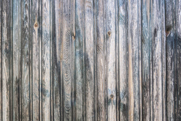 Wooden plank old cracked gray faded wall surface wallpaper background backdrop stock photo