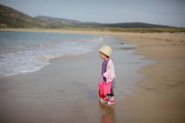 istock baby girl playing at summer beach 1022850534