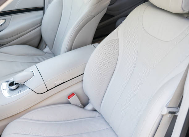 istock Car inside. Interior of a car. Comfortable leather white seats. white perforated leather. Car interior details. Car detailing 1022850864