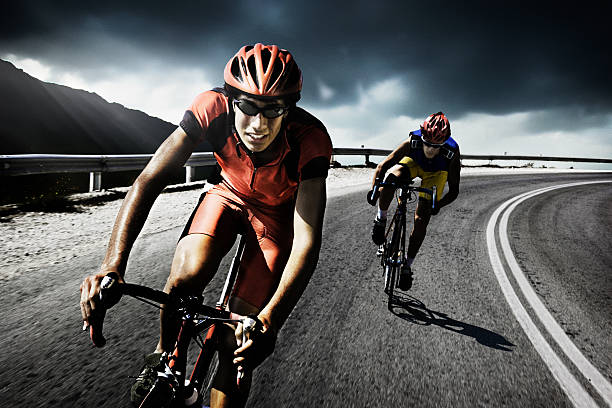 Racing cyclists on road  cycling vest photos stock pictures, royalty-free photos & images