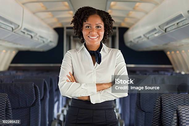 Stewardess On Airplane Stock Photo - Download Image Now - Cabin Crew, Air Stewardess, Airplane