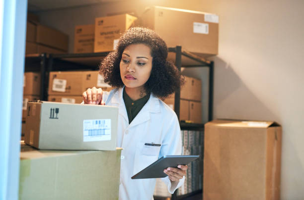 Coordinating the stock control process with smart technology Shot of a young woman using a digital tablet while doing inventory in the storeroom of a pharmacy medical supplies stock pictures, royalty-free photos & images