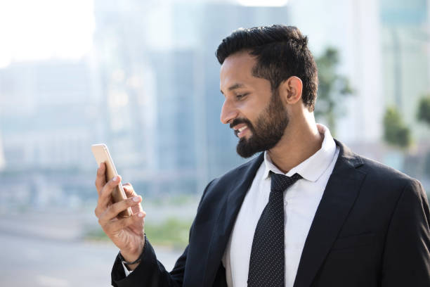 istock Businessman text messaging on mobile phone 1022855272