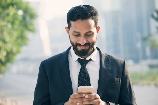 istock Businessman text messaging on mobile phone 1022855306