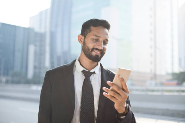 istock Businessman text messaging on mobile phone 1022855380