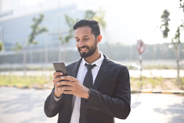istock Businessman text messaging on mobile phone 1022855406