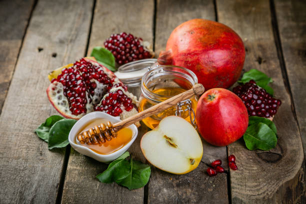 Rosh hashana jewish holiday concept - apples, honey, pomegranate stock photo