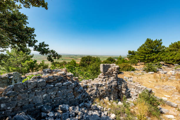 riene, ancient city of Ionia about 6 miles (10 km) north of the Menderes (Maeander) River and 10 miles (16 km) inland from the Aegean Sea, in southwestern Turkey. Its well-preserved remains are a major source of information about ancient Greek town planning.
By the 8th century BC Priene was a member of the Ionian League, whose central shrine, the Panionion, lay within the city’s territory. Priene was sacked by Ardys of Lydia in the 7th century BC but regained its prosperity in the 8th. Captured by the generals of the Persian king Cyrus (c. 540), the city took part in several revolts against the Persians (499–494). Priene originally lay along the Maeander River’s mouth, but about 350 BC the citizens built a new city farther inland, on the present site. The new city’s main temple, of Athena Polias, was dedicated by Alexander the Great in 334. The little city grew slowly over the next two centuries and led a quiet existence; it prospered under the Romans and Byzantines but gradually declined, and after passing into Turkish hands in the 13th century AD, it was abandoned. Excavations of the site, which is occupied by the modern town of Samsun Kale, began in the 19th century.
Modern excavations have revealed one of the most beautiful examples of Greek town planning. The city’s remains lie on successive terraces that rise from a plain to a steep hill upon which stands the Temple of Athena Polias. Built by Pythius, probable architect of the Mausoleum of Halicarnassus, the temple was recognized in ancient times as the classic example of the pure Ionic style. Priene is laid out on a grid plan, with 6 main streets running east-west and 15 streets crossing at right angles, all being evenly spaced. The town was thereby divided into about 80 blocks, or insulae, each averaging 150 by 110 feet (46 by 34 m). About 50 insulae are devoted to private houses; the better-class insulae had four houses apiece, but most were far more subdivided. aydin - turquía. 03 de junio, ruinas de la antigua ciudad de priene. soke, aydin - turkey.priene es una antigua ciudad helenística situada justo al norte de mileto en turquía occidental. fue una antigua ciudad griega de santo y el inicio de un importan
