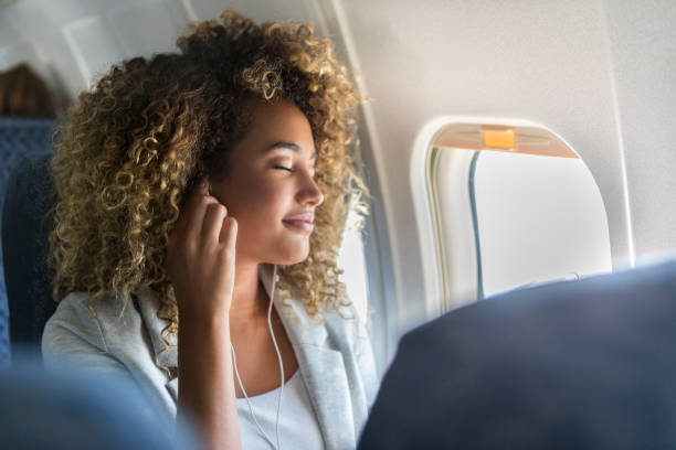 istock Woman listens to music during flight 1022880174