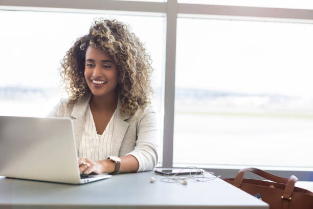 Young woman works while waiting for flight