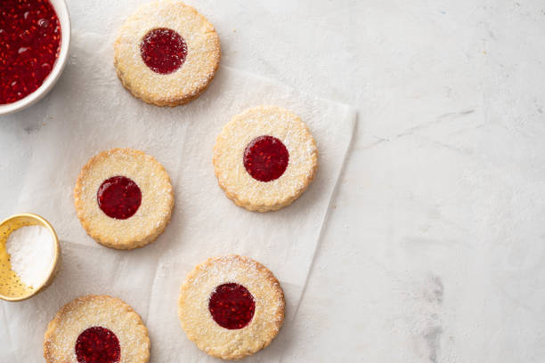 istock Christmas cookies. Linzer cookies with raspberry jam on white table background. Traditional Austrian biscuits filled. Top view and copy space 1022880502