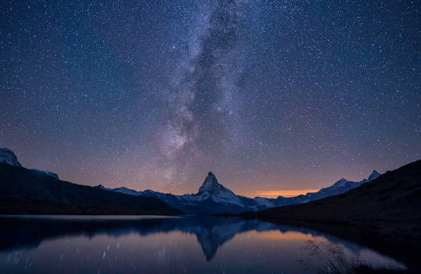 cervino, una via lattea e un riflesso vicino al lago di notte, svizzera - switzerland lake mountain landscape foto e immagini stock