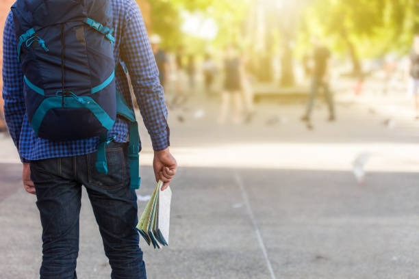 istock Young man traveler with backpack and with map. Travel concept 1022885534