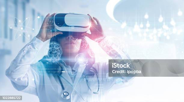 Medical Technology Concept Mixed Media Female Doctor Wearing Virtual Reality Glasses Checking Brain Testing Result With Simulator Interface Innovative Technology In Science And Medicine Stock Photo - Download Image Now