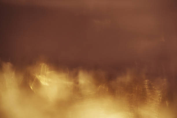 istock abstract background. Golden sparks and a cloud of dust 1022885814