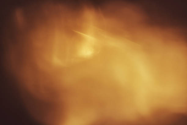 istock abstract background. Golden sparks and a cloud of dust 1022885816