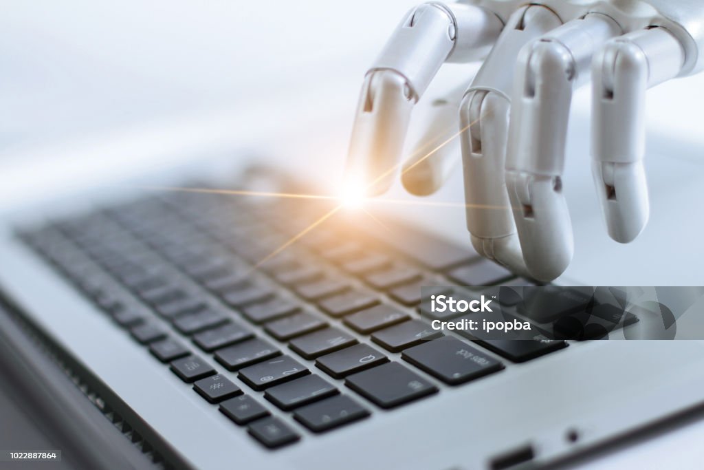 Robot finger point and working to laptop keyboard button, AI, Artificial Intelligence, Robotic hand on digital gray background. Futuristic technology concept. Robot Stock Photo
