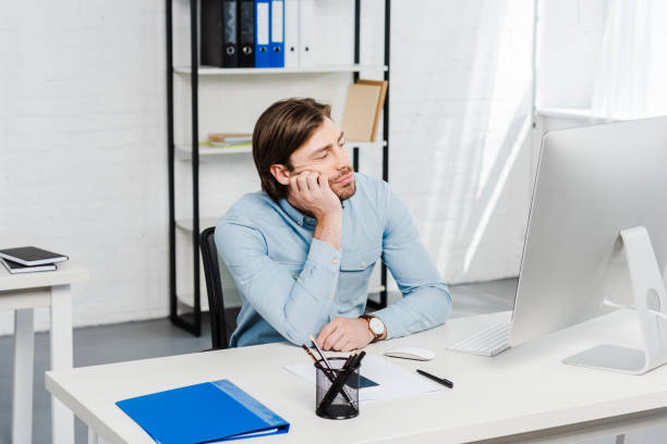 istock bored young businessman looking at computer monitor at office 1022891768