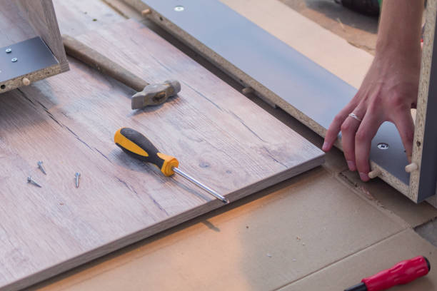 istock furniture assembling - Carpentry screws for a knock down wooden table. 1022892194