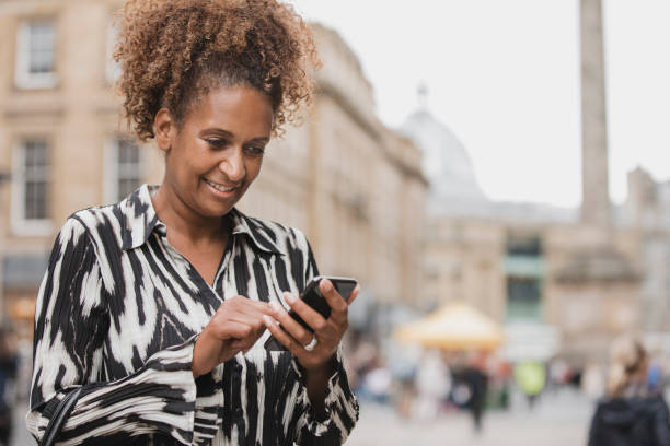 istock Businesswoman Using A Smartphone In Newcastle City Centre 1022898190