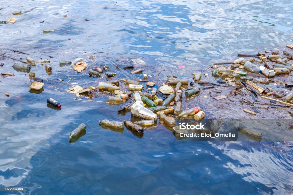 Plastic waste floating in the ocean different Plastic waste floating in the sea Sea Stock Photo