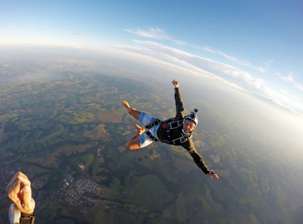istock Barefoot man jumping from parachute at sunset. 1022904484