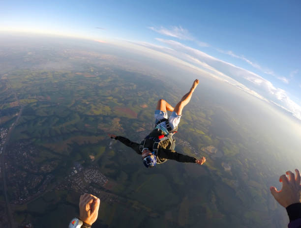 istock Barefoot man jumping from parachute at sunset. 1022904498