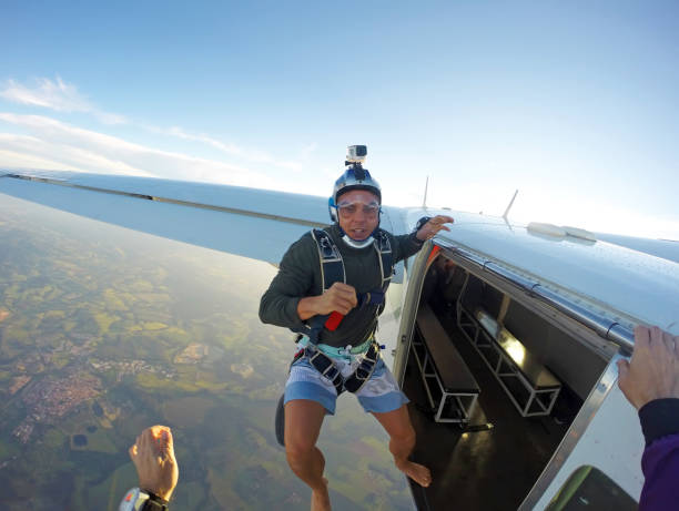 istock Barefoot man jumping from parachute at sunset. 1022904510