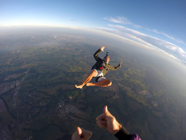 istock Barefoot man jumping from parachute at sunset. 1022904550