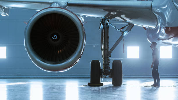 istock In a Hangar Aircraft Maintenance Engineer/ Technician/ Mechanic Visually Inspects Airplane's Jet Engine. 1022905196