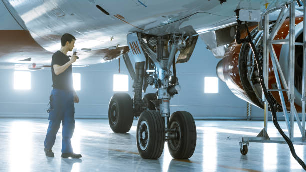 istock In a Hangar Aircraft Maintenance Engineer/ Technician/ Mechanic Visually Inspects Airplane's Chassis. 1022905208