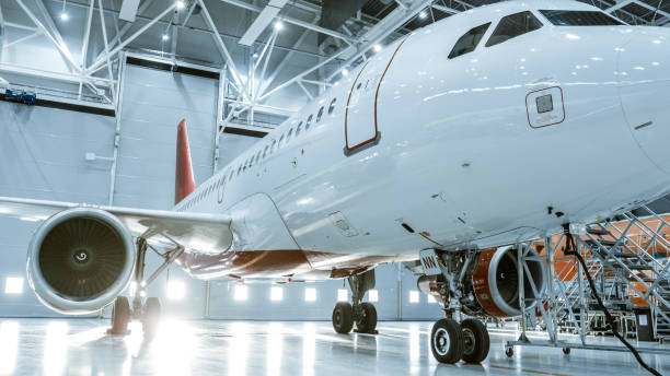 In Aircraft Maintenance Hangar Standing Clean Brand New Plane. In Aircraft Maintenance Hangar Standing Clean Brand New Plane. airplane hangar photos stock pictures, royalty-free photos & images