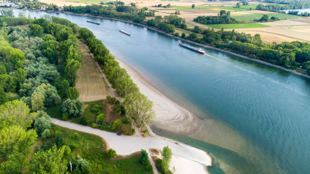 Industrial ships on Rhine river - very low water level during drought in summer 2018