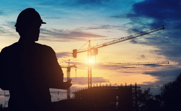 Silhouette engineers are standing work on construction. stock photo