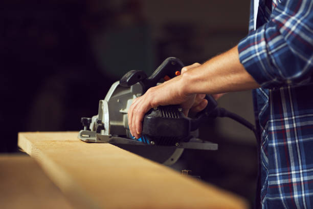 istock The carpenter using circular saw for cutting a wooden plank 1022911014