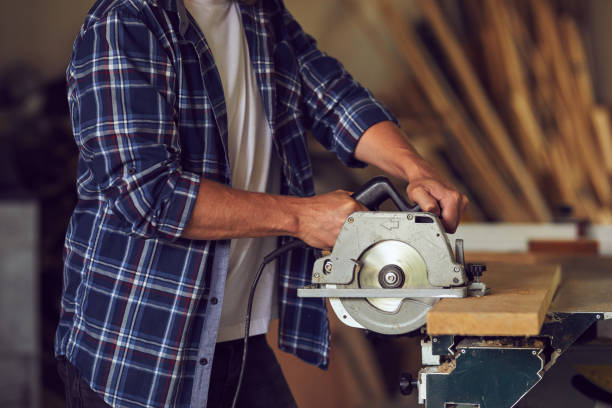 istock The carpenter using circular saw for cutting wooden board 1022911052
