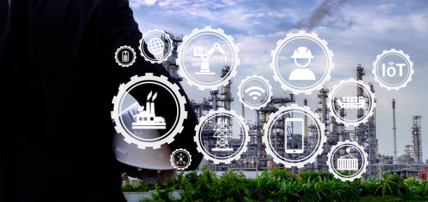 istock The engineer is holding a helmet with large industry background. 1022911398
