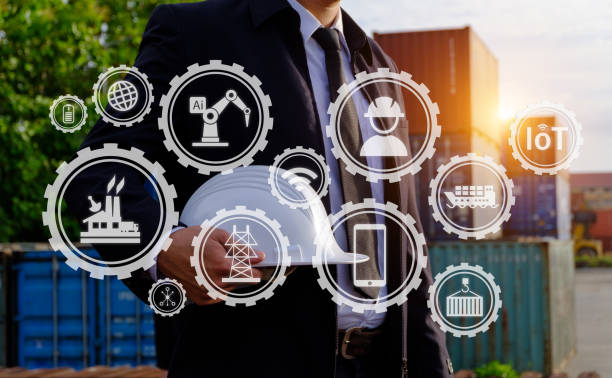 istock The engineer is holding a helmet with large industry background. 1022911444