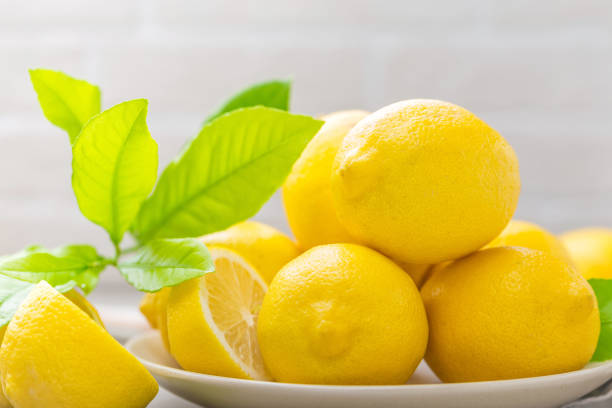 istock Fresh lemons with lemon leaves 1022916588