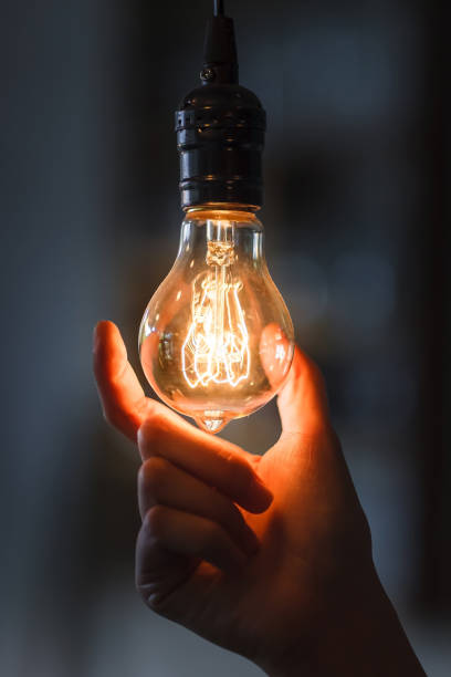 istock Lightbulb with filament held in woman hand 1022920514